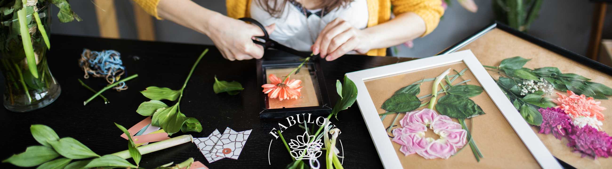Person crafting floral art using fresh flowers, showcasing creativity and elegance with Fabulous Flowers and Gifts
