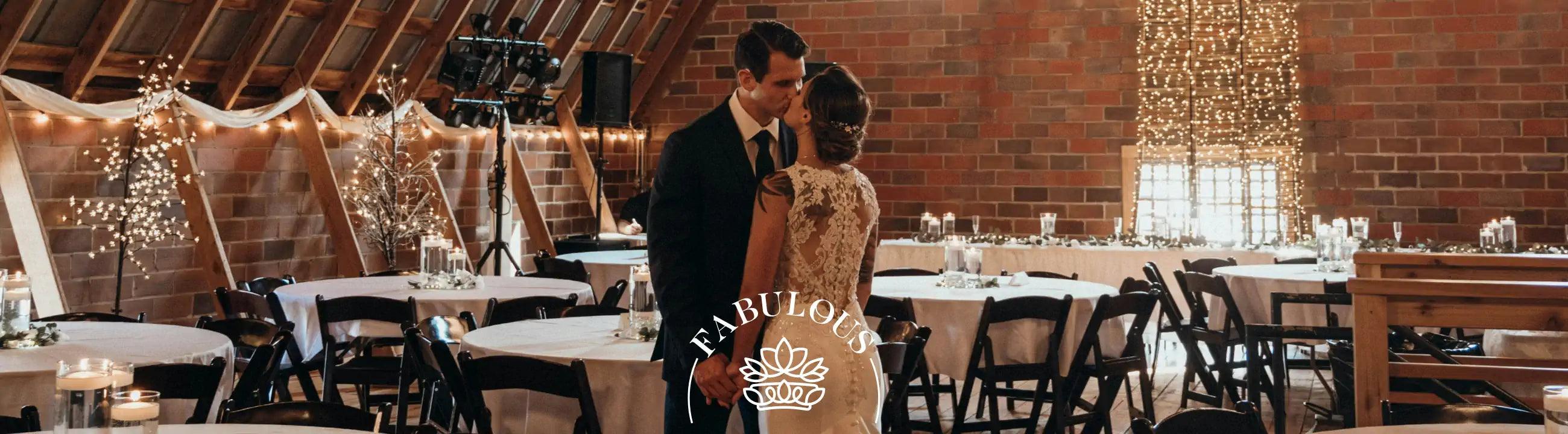 Bride and groom sharing a kiss in a beautifully decorated venue