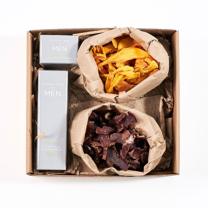 A Gentleman’s Pause - Fabulous Flowers & Gifts men's gift box with biltong, dried mango, and Pepper Tree grooming products.