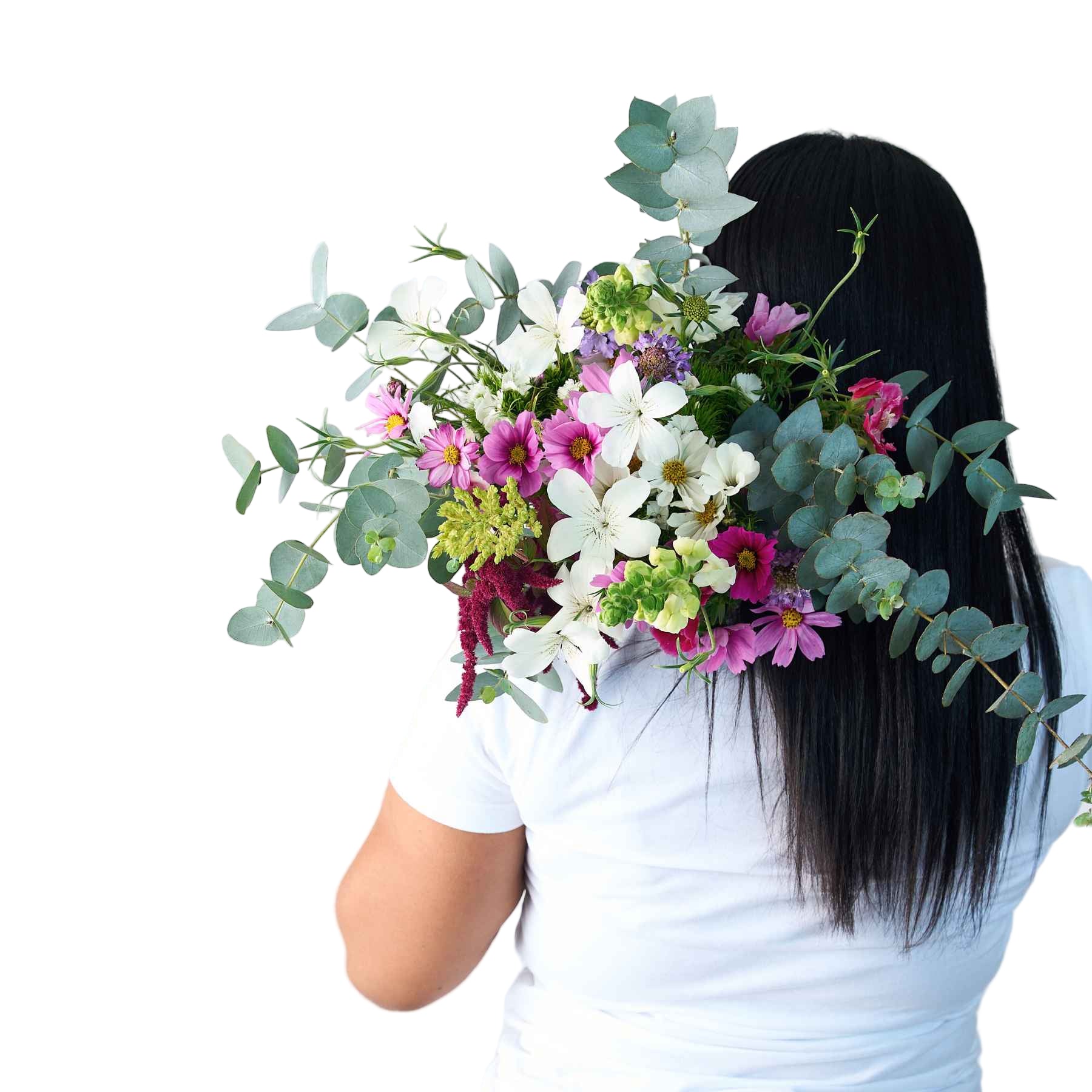 Back view of a woman holding a lush bouquet of wildflowers and greenery over her shoulder, symbolising the natural beauty of the 'A Walk in the Woods' bouquet.