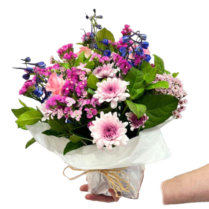 Bouquet of flowers held by a hand on a white background