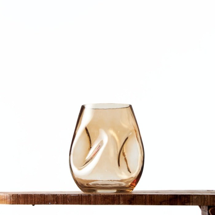 Elegant Amber Vase with a unique organic shape and warm golden tones, ideal for contemporary or rustic decor settings.