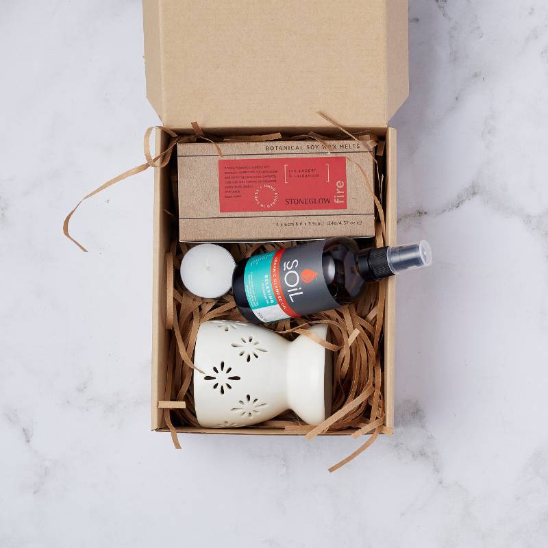 Aromatherapy Bliss Gift Set featuring soy wax melts, relaxing blended oil, a ceramic oil burner, and a tea light candle, beautifully presented.