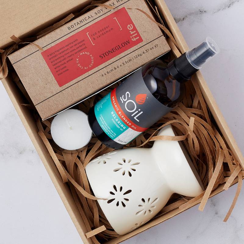 Close-up of the Aromatherapy Bliss Gift Set with soy wax melts, relaxing oil, a ceramic diffuser, and a candle for an aromatherapy experience.