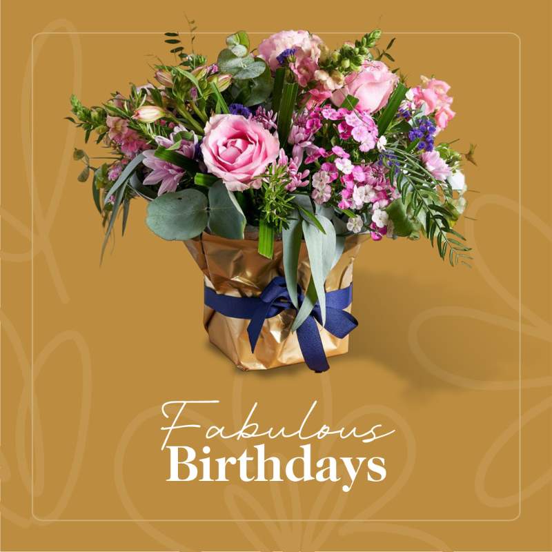 Bright and colourful birthday bouquet arrangement wrapped in gold, perfect for celebrating special birthdays.