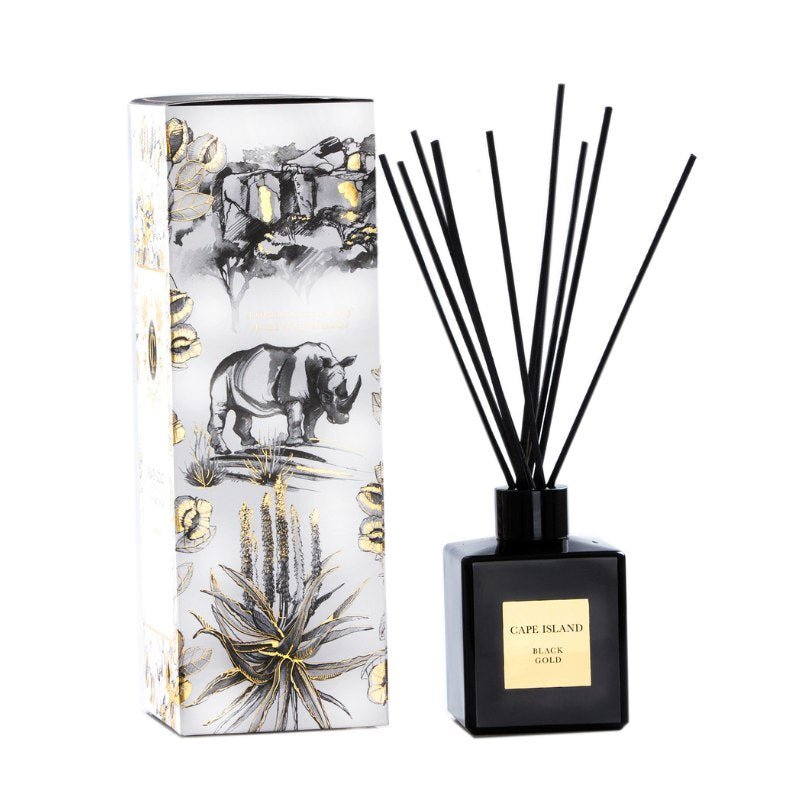 Diffuser with black sticks and a decorative box featuring a rhino illustration on a white background