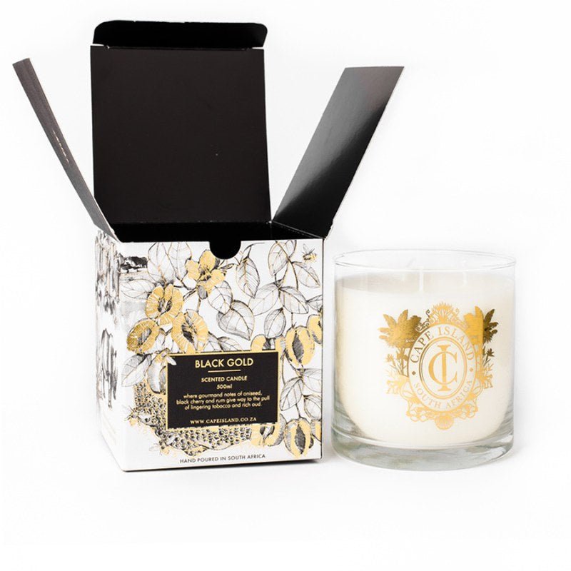 Candle with decorative packaging featuring gold and black design on a white background