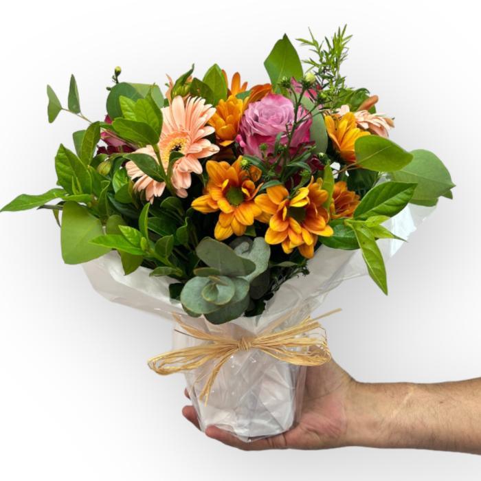 Bliss Posy by Fabulous Flowers & Gifts – bright and joyful bouquet with peach, orange, and pink blooms in rustic wrap