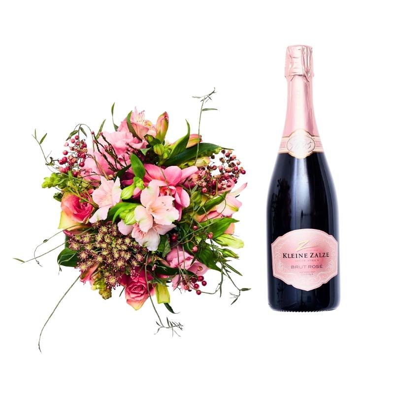 Small pink bouquet with sparkling wine bottle on white background, celebration gift set