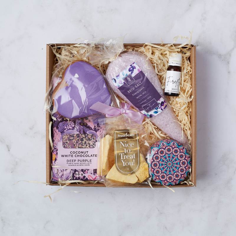 Calm and Comfort Gift Box featuring purple heart bath bomb, lavender bath salts, coconut white chocolate, fragrance oil, and biscuits.