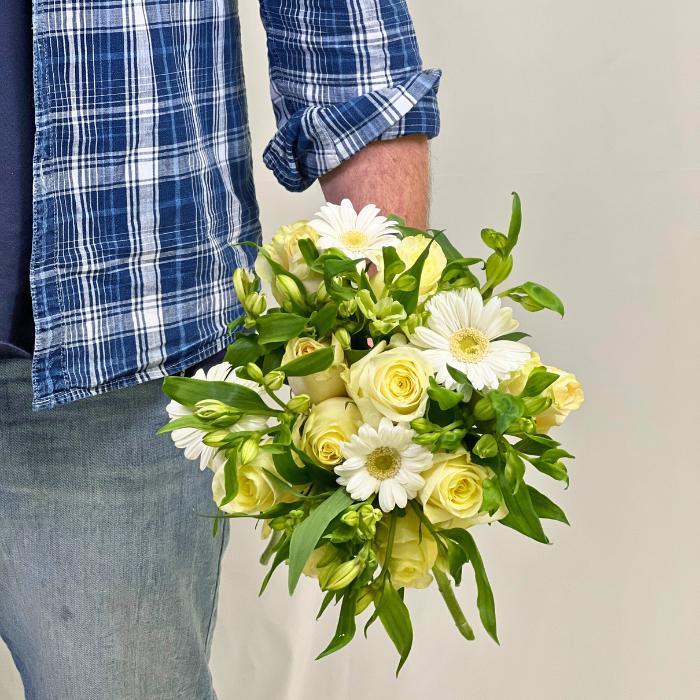 Celestial Charm Flower Bouquet – fresh white gerberas, creamy roses, and green foliage, hand-held by man in denim and plaid