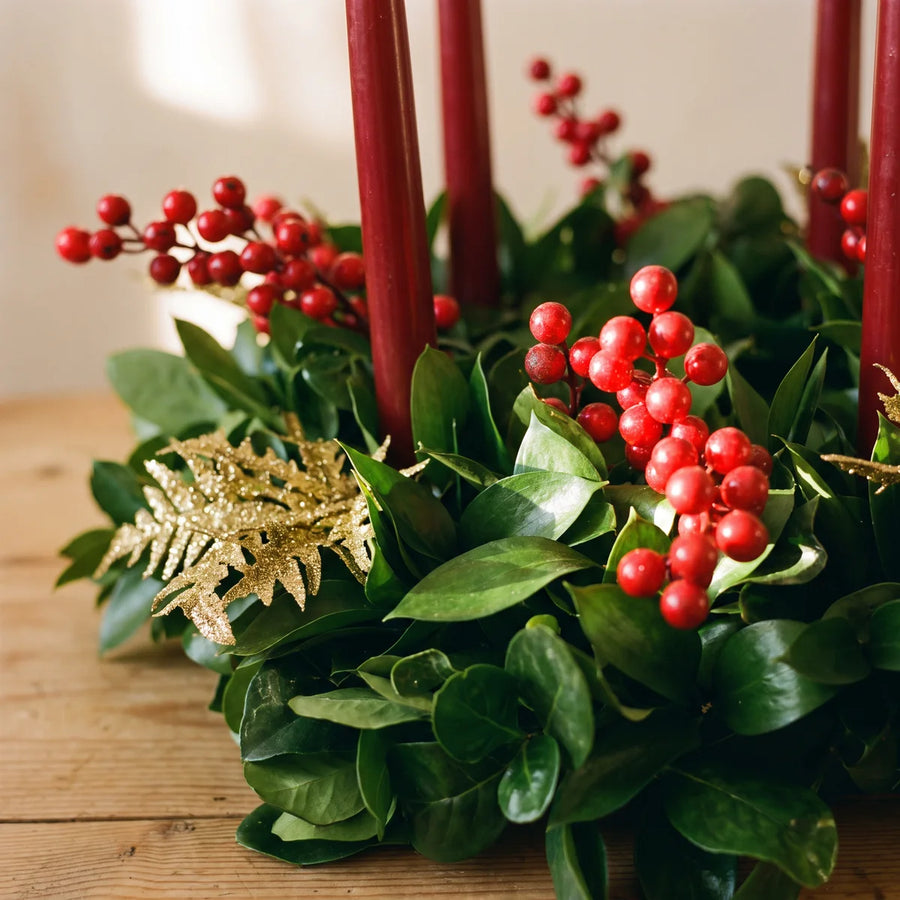 Close-up of glossy red berries, gold glitter fern and red candles in a fresh green wreath, Fabulous Flowers South Africa
