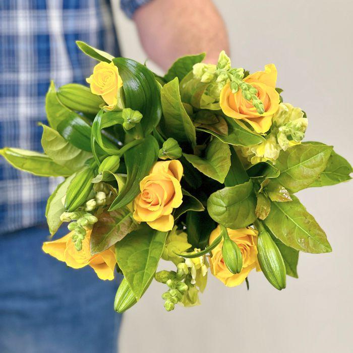 Hand-held yellow rose bouquet with lush green foliage and buds – fresh floral arrangement by Fabulous Flowers & Gifts