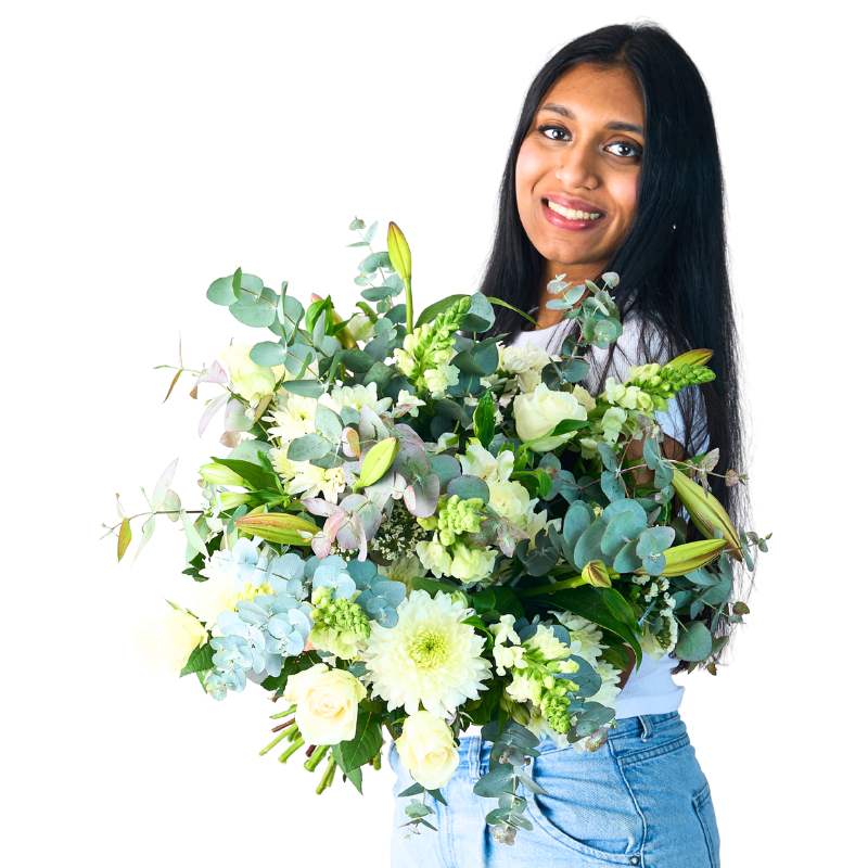 Classic White Bouquet held by model, white roses and lilies with eucalyptus greenery on white background
