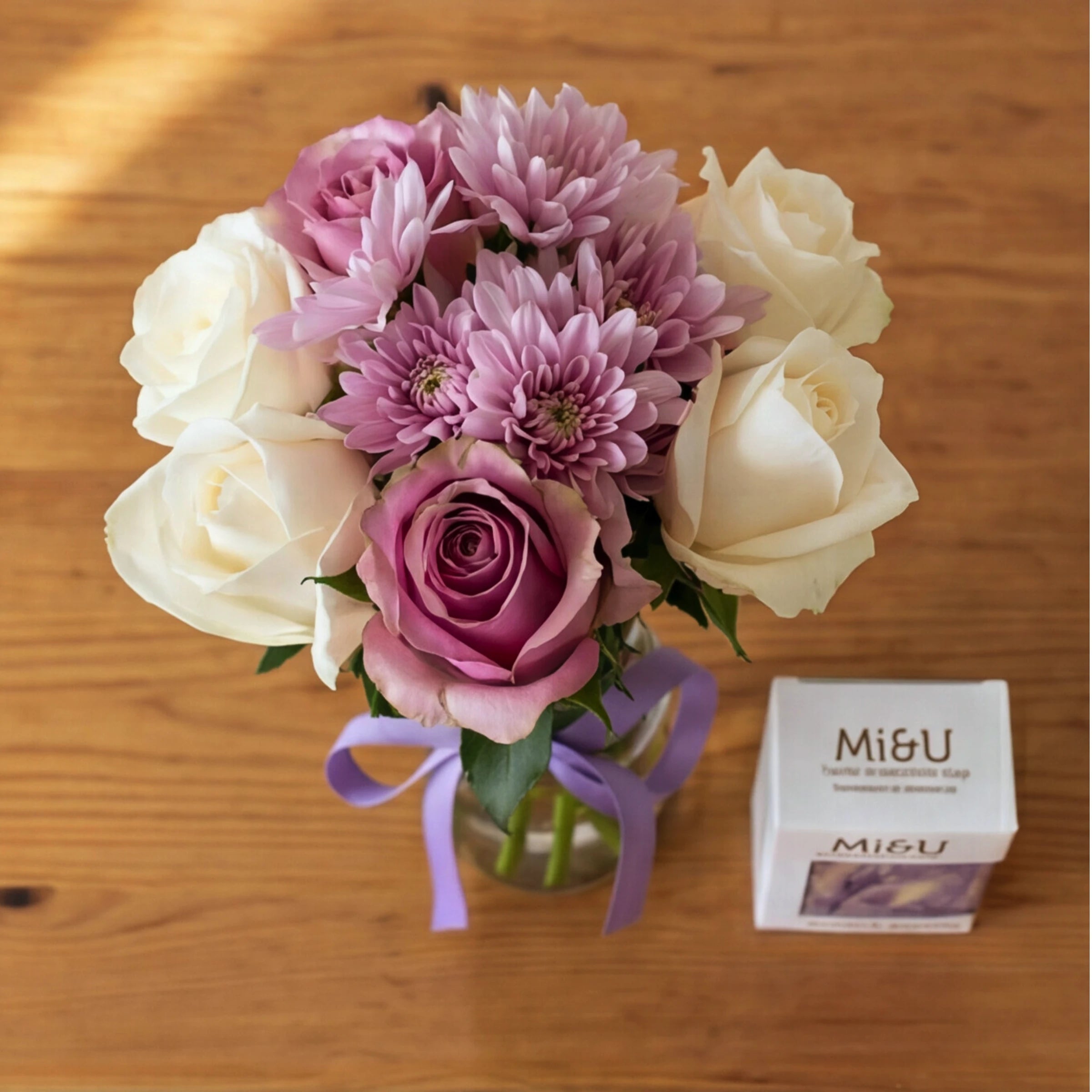 Top-down view of the Cleanse & Calm posy of mauve, pink and cream roses with the Mi&U soap