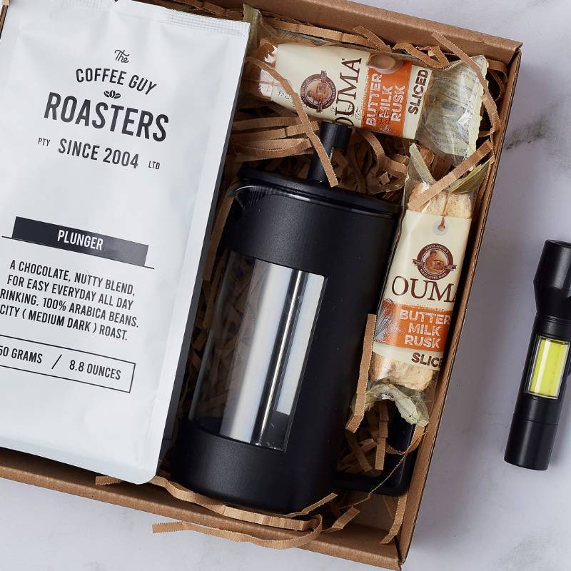 Close-up of items in Coffee Lover's Escape Gift Box, showing coffee plunger, roasted coffee beans, and buttermilk rusks.
