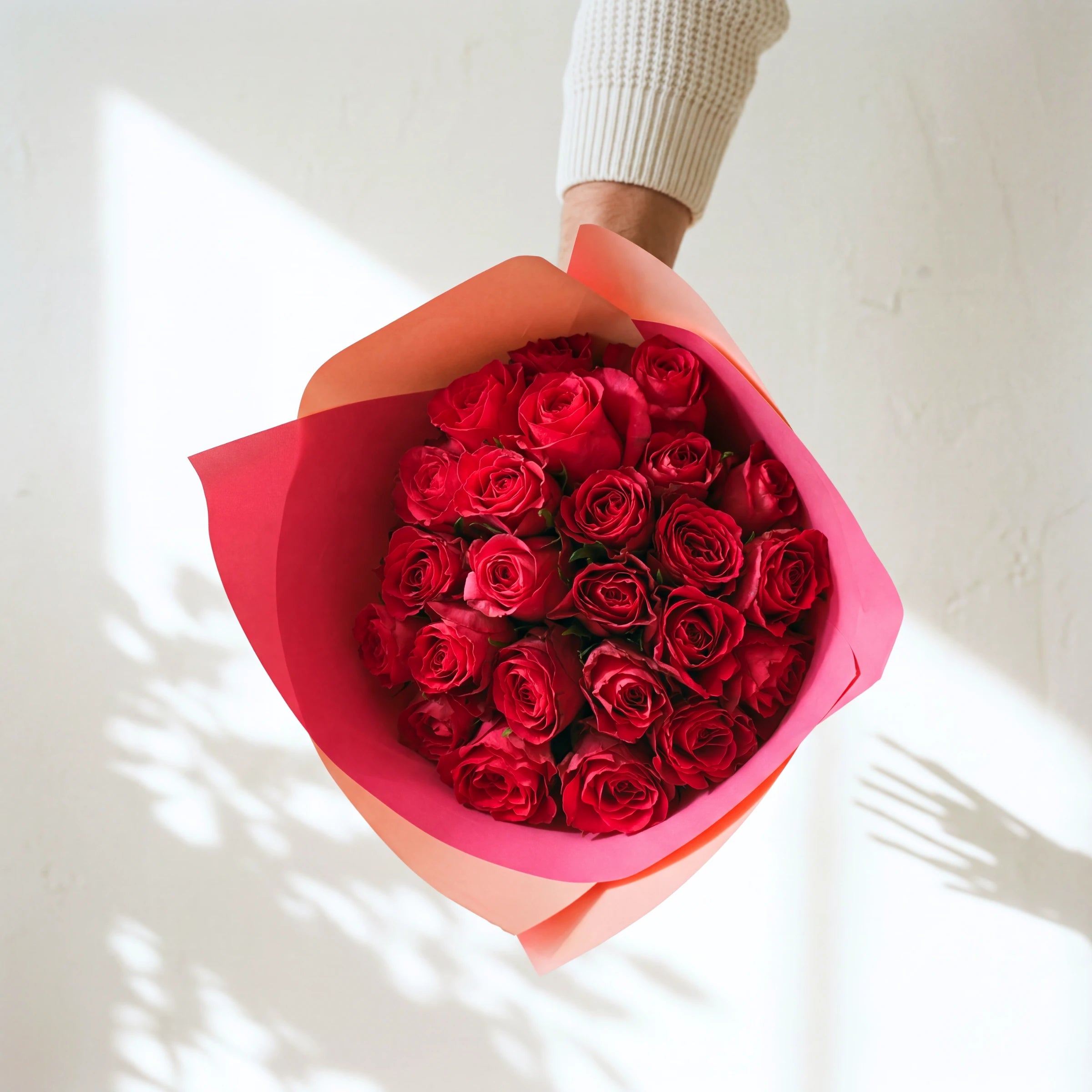 The Cosmo bouquet, two dozen hot pink roses in a pink and coral wrap, same-day in Cape Town and Joburg