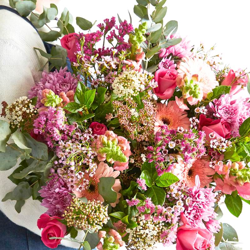 Bouquet of pink and green flowers with a white vase.