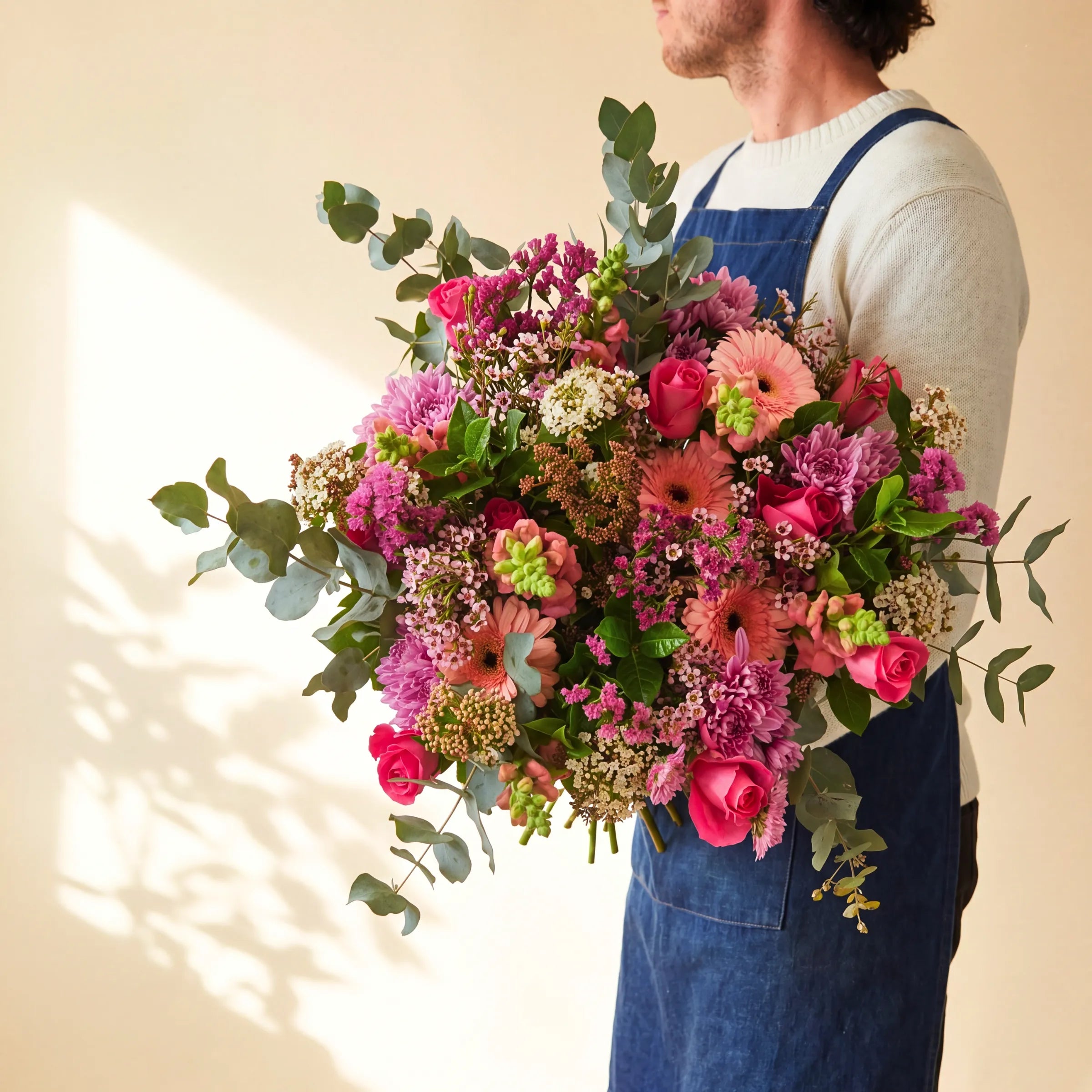 Country Garden Bouquet abundant pink and peach hand-tied flower bouquet with trailing silver eucalyptus by Fabulous Flowers