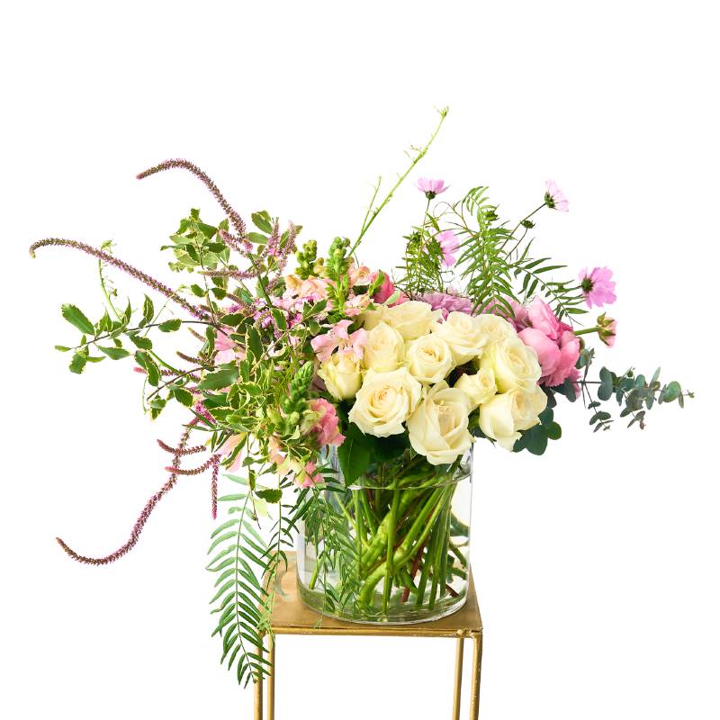 Modern arrangement flowers in a clear vase on a white background