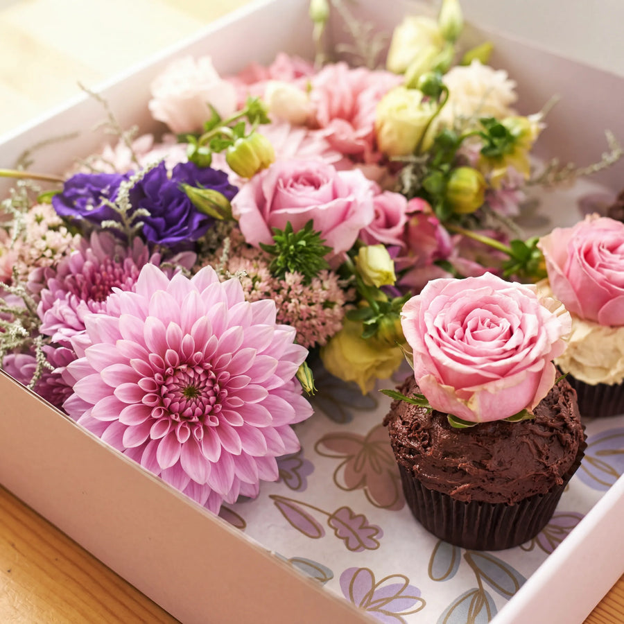 Detail of pink dahlia, roses and chocolate cupcake with fresh rose topper by Fabulous Flowers Claremont