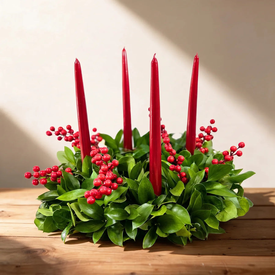 Green table wreath with four red candles and sprigs of red berries on a pine table, Fabulous Flowers South Africa