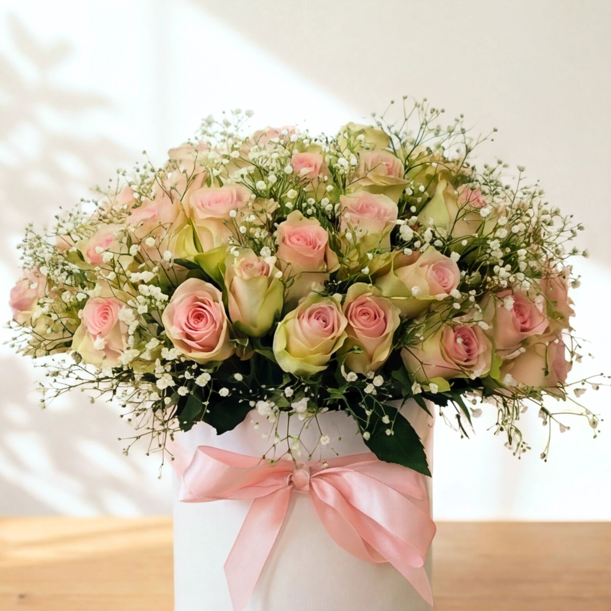 Close up of the Duchess hatbox showing pink roses, baby's breath and a pale pink ribbon