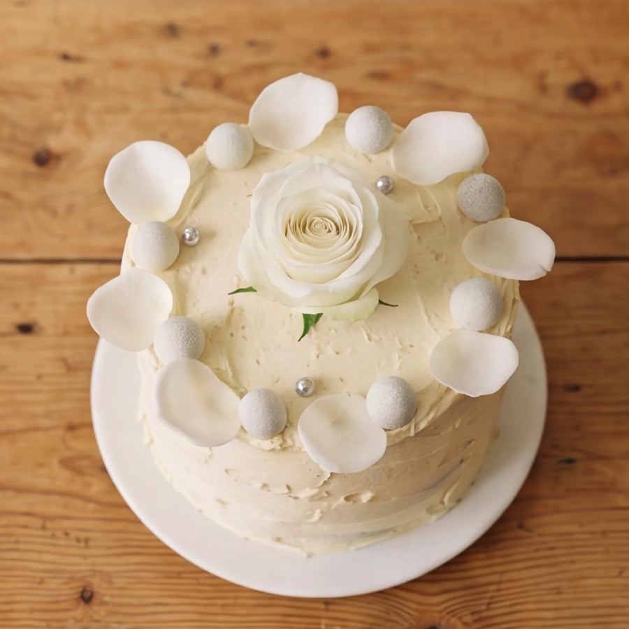 Close-up of white rose centre and silver pearl crown on Elegant Rose Celebration Cake by Fabulous Flowers