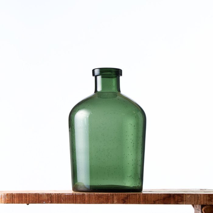 Emerald Essence Vase: a striking green glass vase with subtle bubbles, capturing a rustic yet elegant aesthetic.