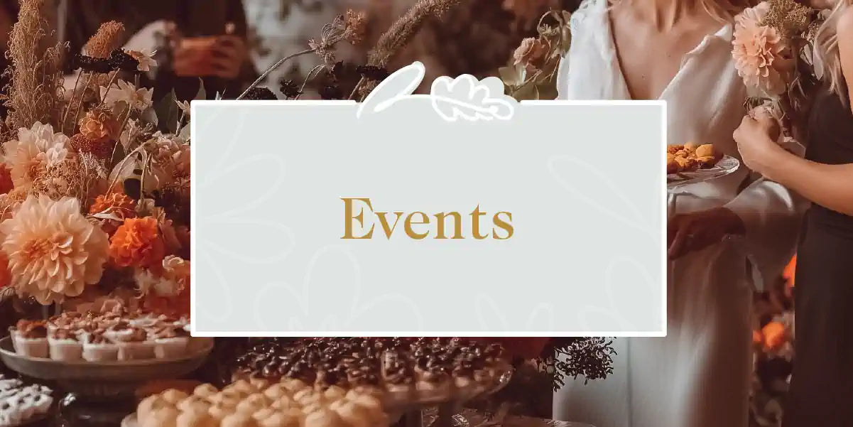 An elegant event setting with a lavish spread of food and floral arrangements. Fabulous Flowers and Gifts - Events