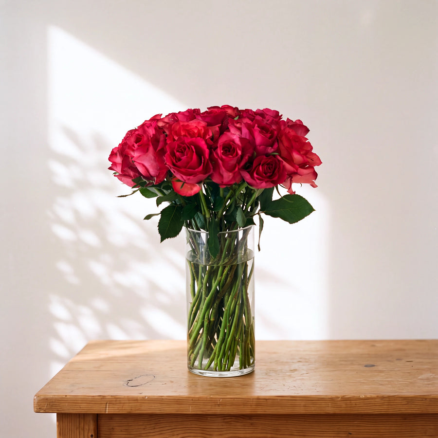Medium Fandango arrangement of vivid hot pink roses in a glass vase, hand-arranged in Cape Town