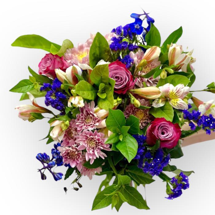Bouquet of colorful flowers including roses and hydrangeas on a white background