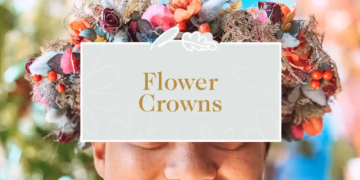 A woman wearing a flower crown made of an assortment of vibrant flowers and berries. Fabulous Flowers and Gifts - Flower Crowns