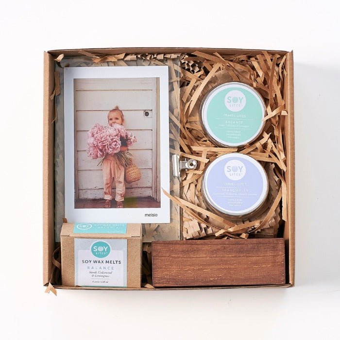 Framed Essence Gift Set with soy candles, wax melts, a framed Meisie print, and a wooden candle holder in kraft box.