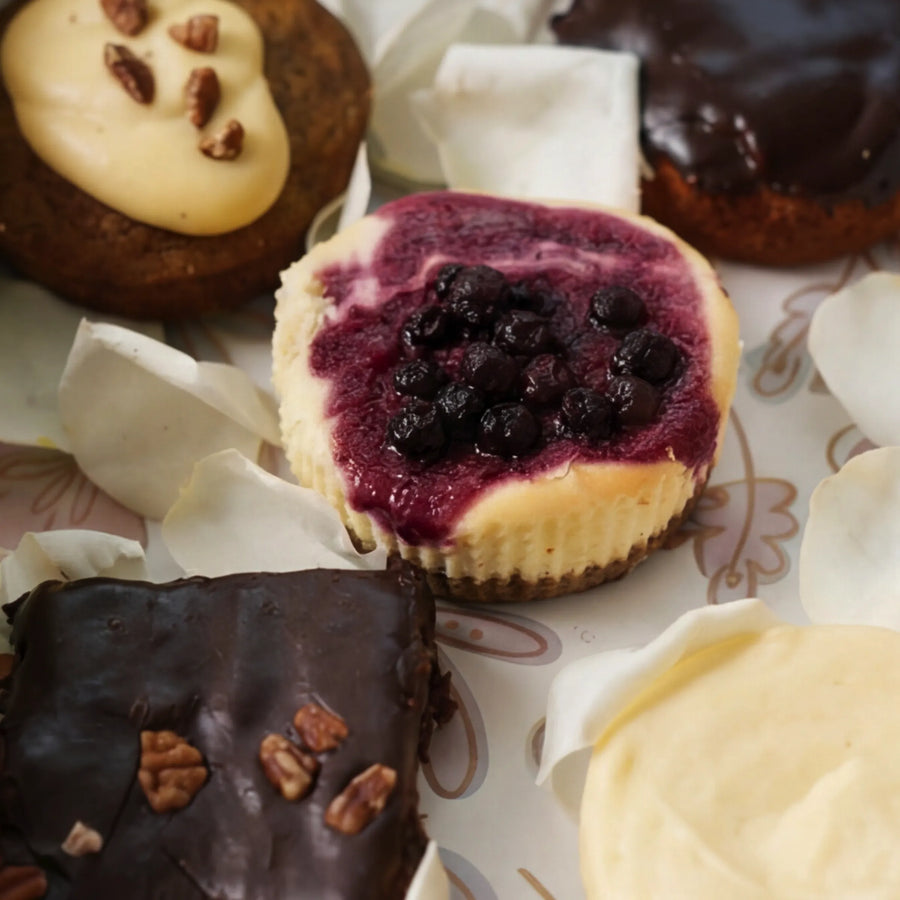 Close-up of blueberry cheesecake, carrot cake and brownie in From Me With Butter box, Claremont studio