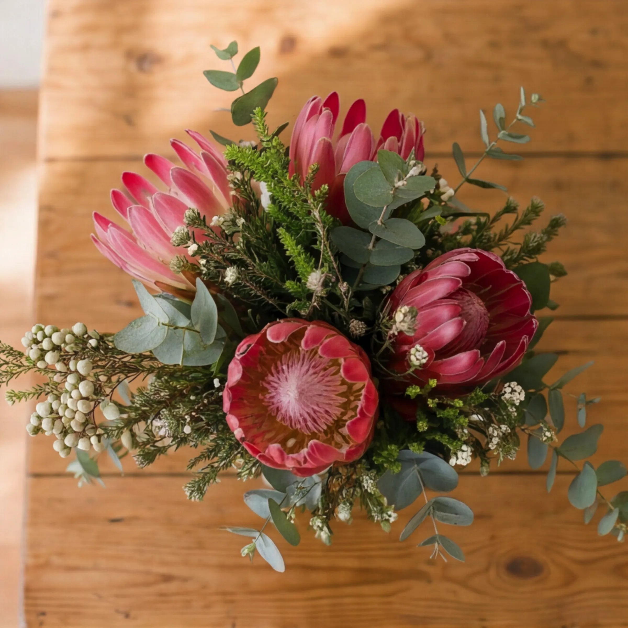 Top view of Fynbos in a Jar with pink proteas, berzelia silver berries, leucadendron and Cape eucalyptus