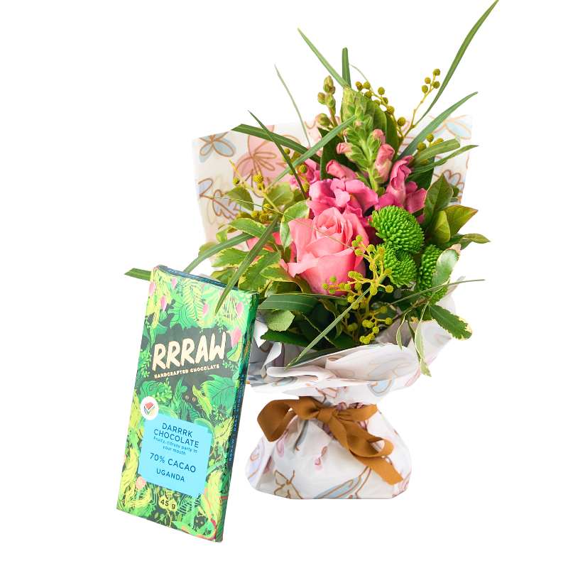 Floral posy with a RRAAW chocolate bar on a white background
