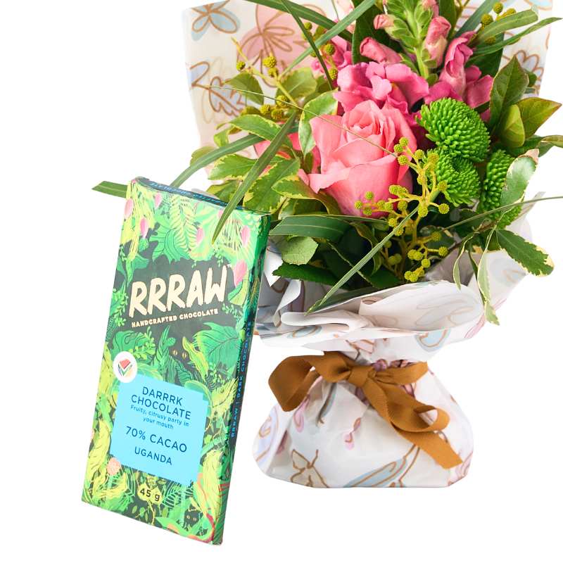 Floral posy with a RRAAW chocolate bar and a small bag on a white background