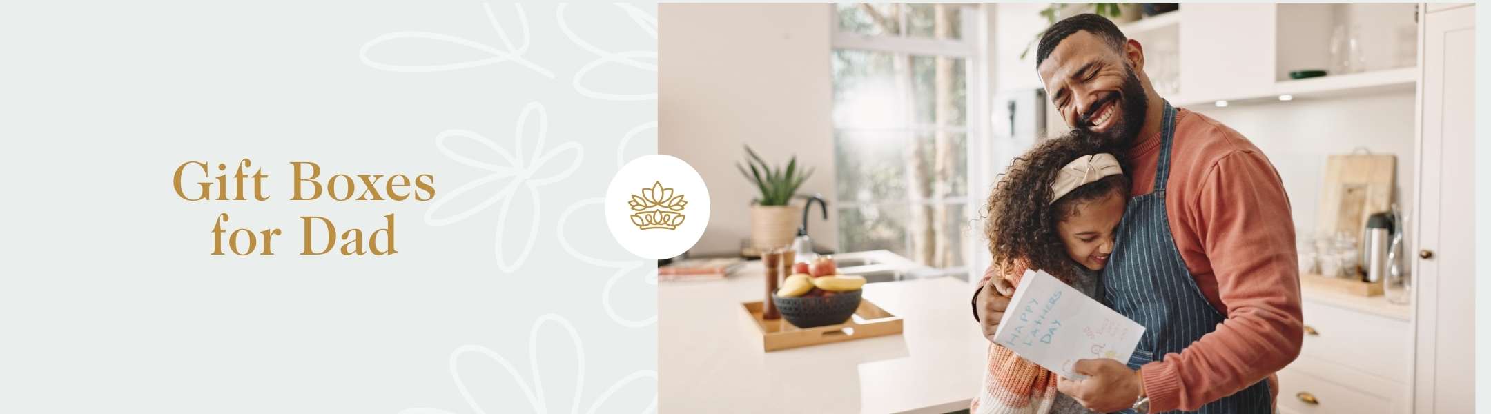 Gift Boxes for Dad text beside a father and daughter hugging in a kitchen, with the daughter holding a Happy Father's Day card.