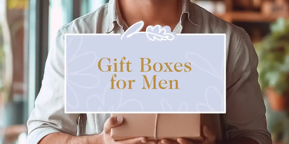 A man in casual attire holding a sophisticatedly wrapped gift box. Fabulous Flowers and Gifts - Gift Boxes for Men