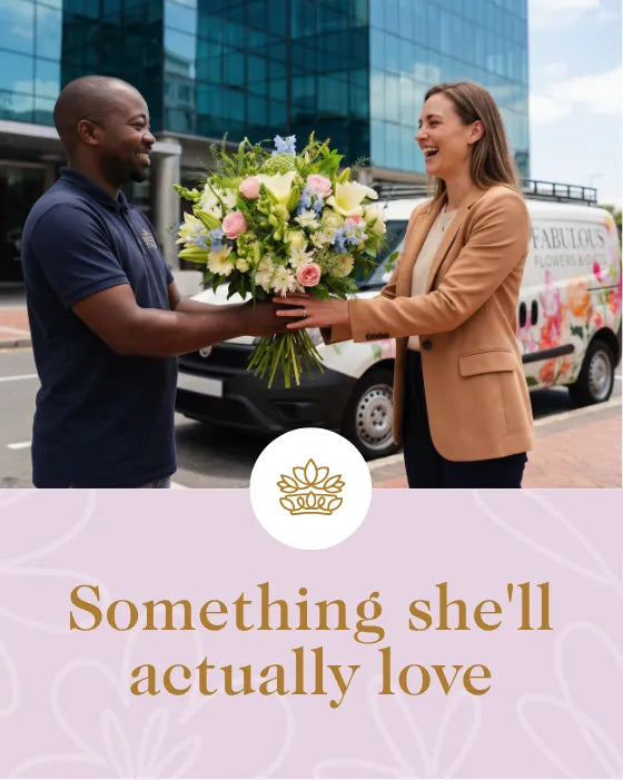 Man handing flowers to a woman with a business van in the background