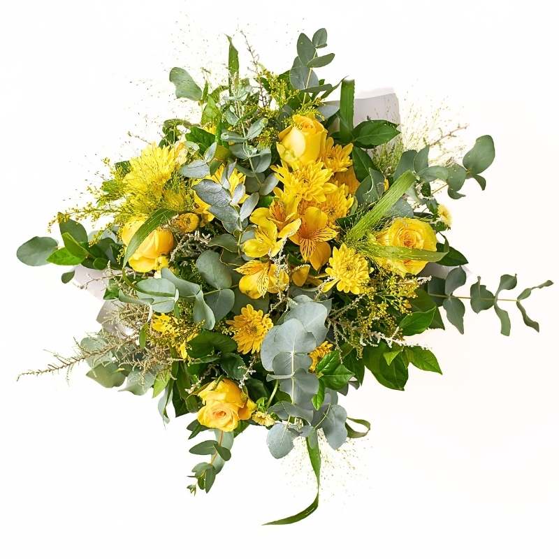 Arrangement of yellow flowers with greenery on a white background