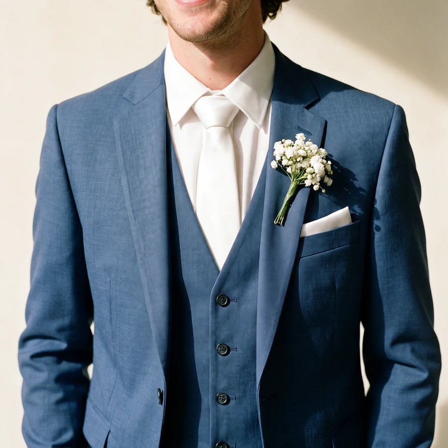 Man in a blue suit and white tie wearing a baby's breath boutonniere, Fabulous Flowers South Africa
