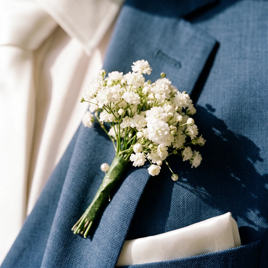 Close-up of a white gypsophila buttonhole on a blue suit lapel, Fabulous Flowers South Africa