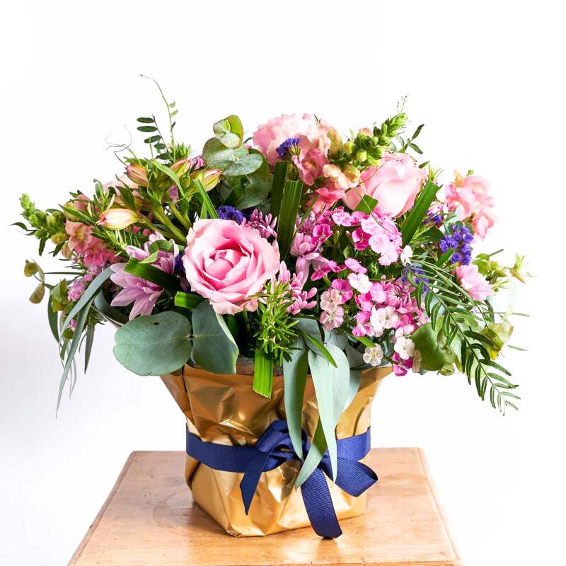 Flower arrangement with Alstromeria, pink roses, purple statice, pink snapdragons, sweet william and wild greenery