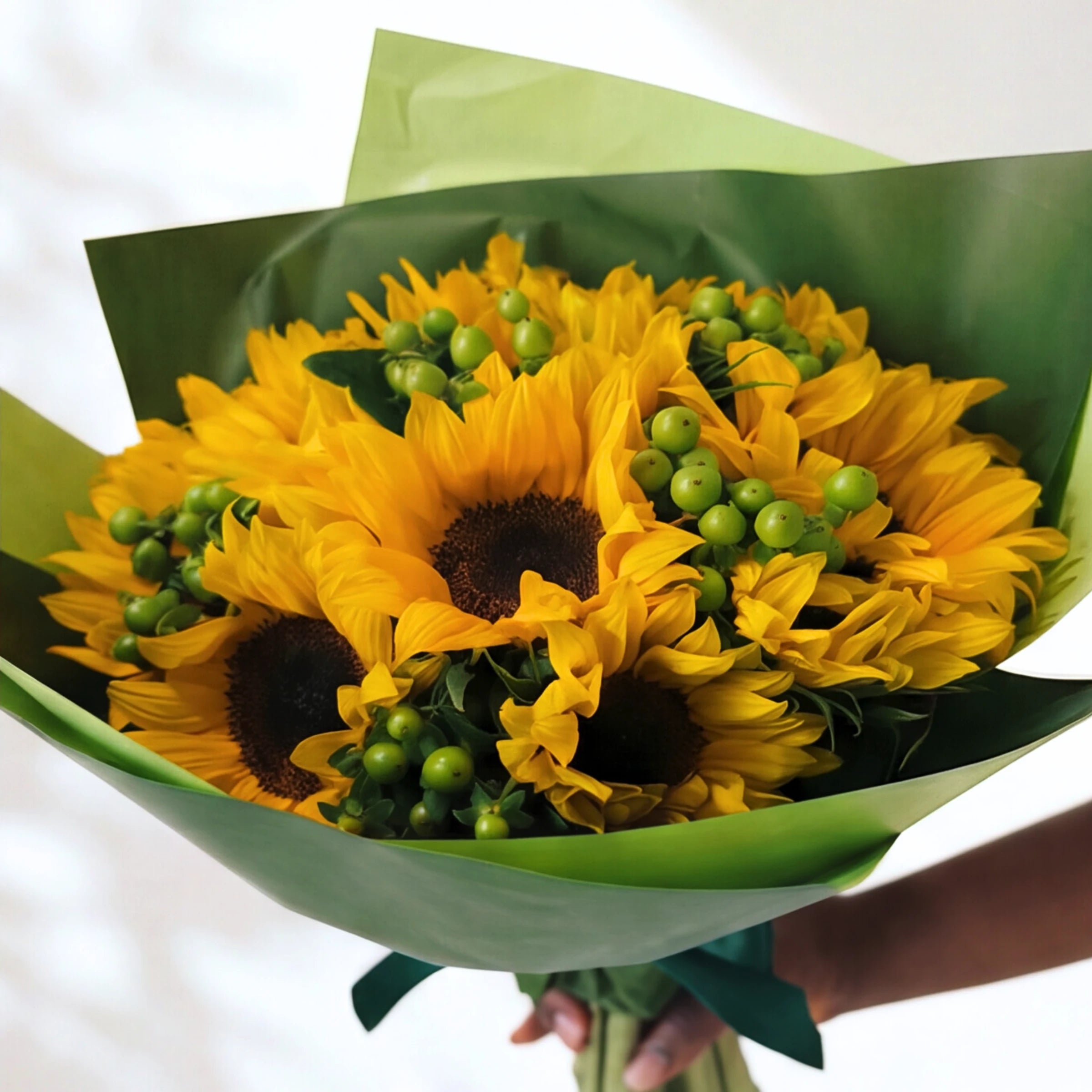 Here Comes the Sun bunch, sunflowers and green hypericum berries wrapped in green