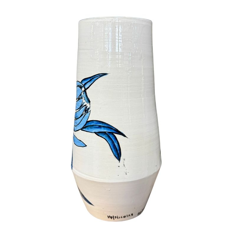 White ceramic vase with blue fish design on a white background