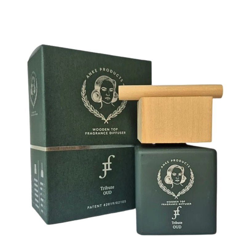 Green wooden top fragrance diffuser with packaging on a white background