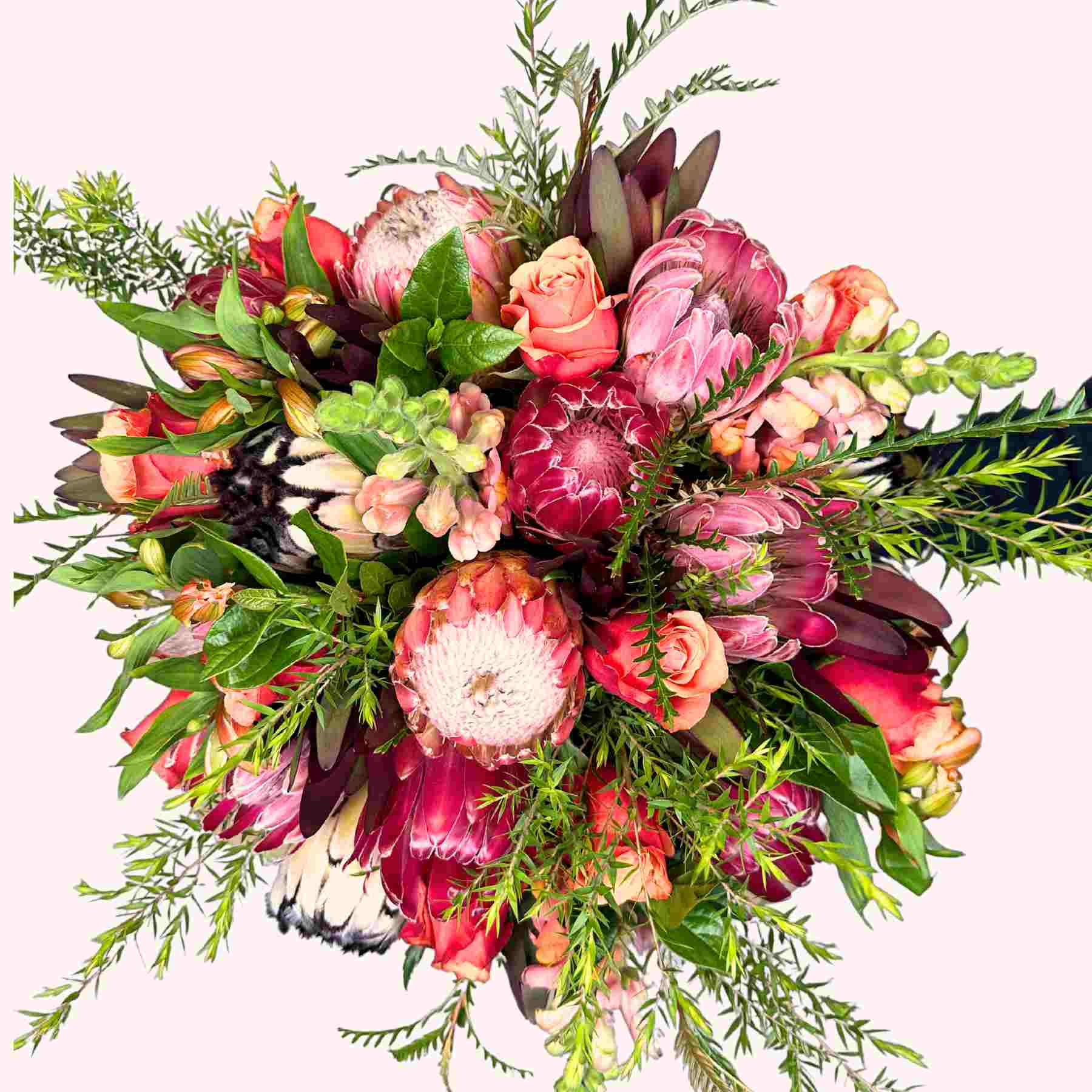 Luxurious arrangement of proteas, roses, and lush greenery in Jayne's Flower Bouquet from Fabulous Flowers and Gifts.