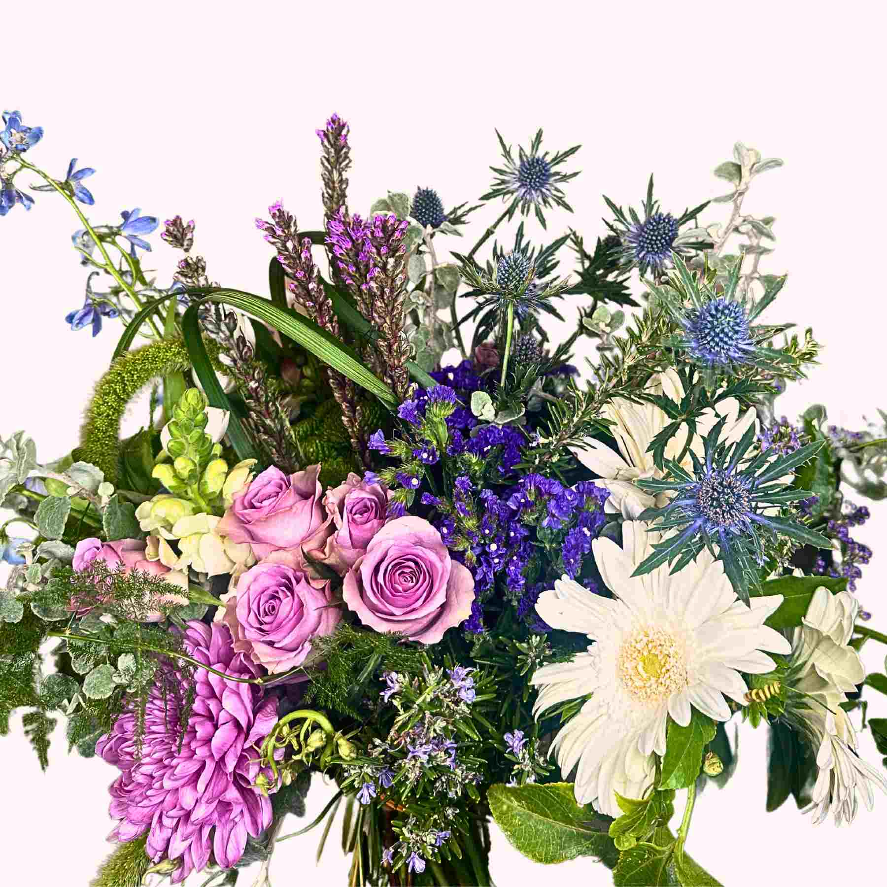 Joy's Flower Bouquet, a stunning mix of purple roses, white gerberas, and blue thistles, from Fabulous Flowers and Gifts.